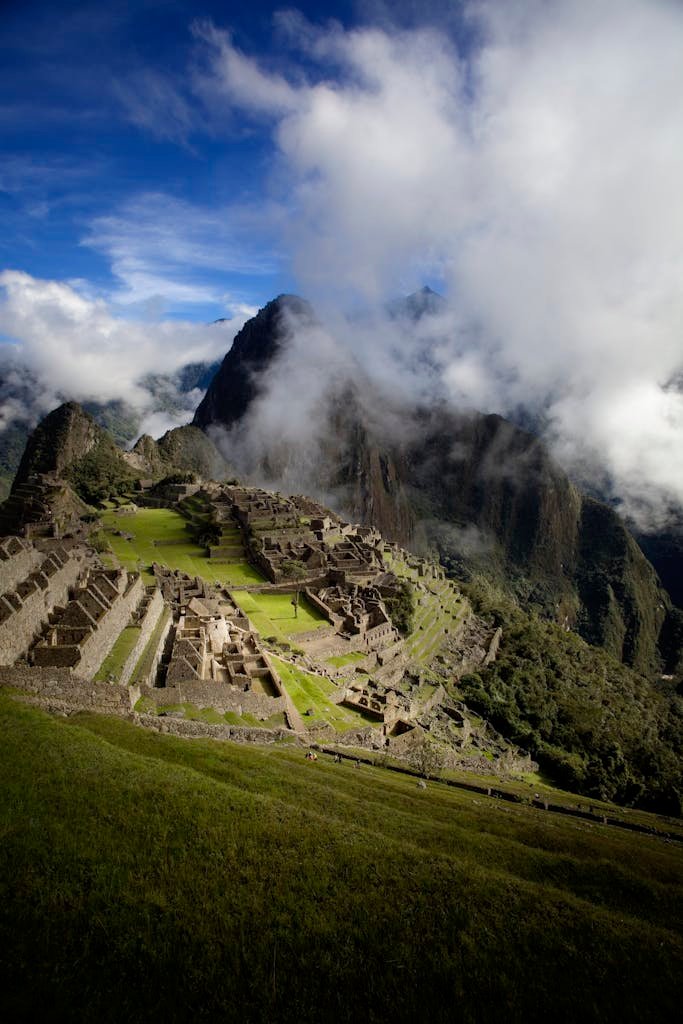 Breathtaking capture of Machu Picchu with dramatic clouds and mountains in Peru.