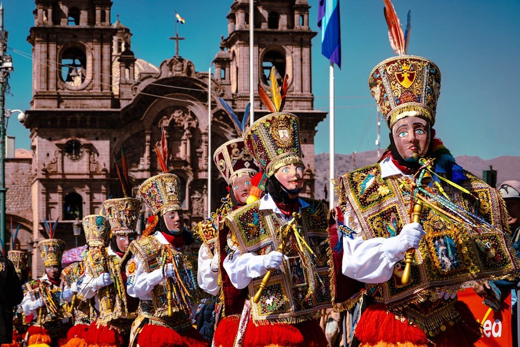 Colorful parade with Andean dancers in traditional attire during a festival in Cusco, Peru.