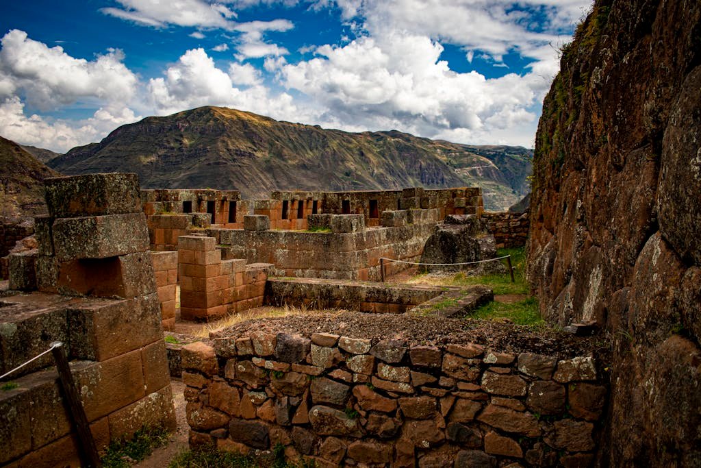 Explore the captivating ancient ruins of Písac set against the majestic Andes mountains.