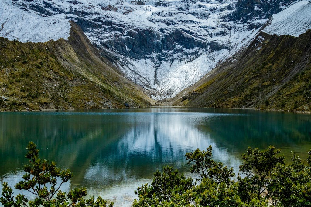 Tranquil Humantay Lake with snow-capped Andes Mountains in Peru, perfect for nature and travel enthusiasts.